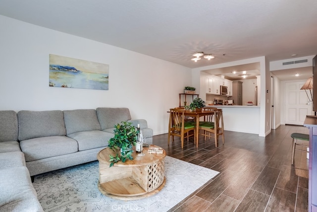240 Nice Ln Unit 114, Newport Beach, CA 92663 - living area with dark wood finished floors and baseboards