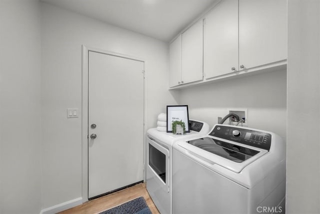 14508 Burin Ave, Lawndale, CA 90260 - laundry area with washing machine and dryer, cabinet space, and light wood-style flooring