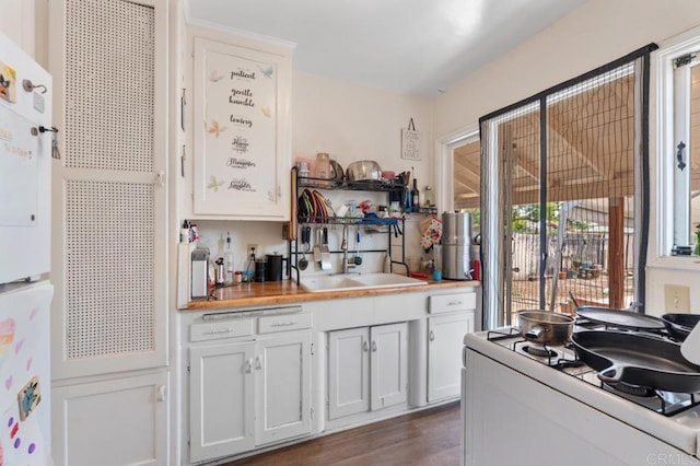 1185 Elm Ave, Chula Vista, CA 91911 - kitchen with white appliances, white cabinets, wood finished floors, and light countertops
