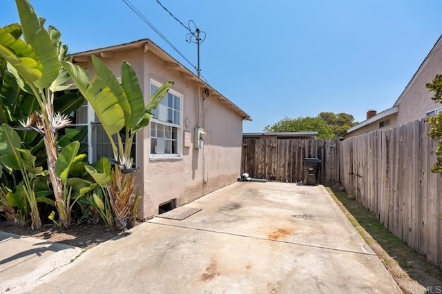 1185 Elm Ave, Chula Vista, CA 91911 - view of side of home with stucco siding, a patio, and a fenced backyard