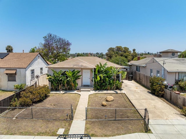 1185 Elm Ave, Chula Vista, CA 91911 - bungalow-style house featuring driveway, a fenced front yard, stucco siding, and a residential view