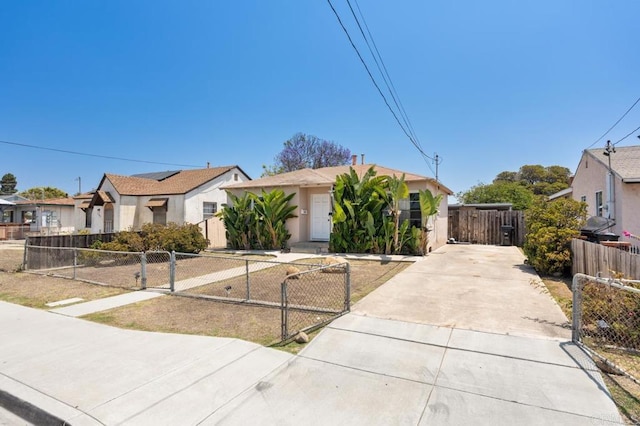 1185 Elm Ave, Chula Vista, CA 91911 - view of front of house with a gate, driveway, a residential view, and a fenced front yard