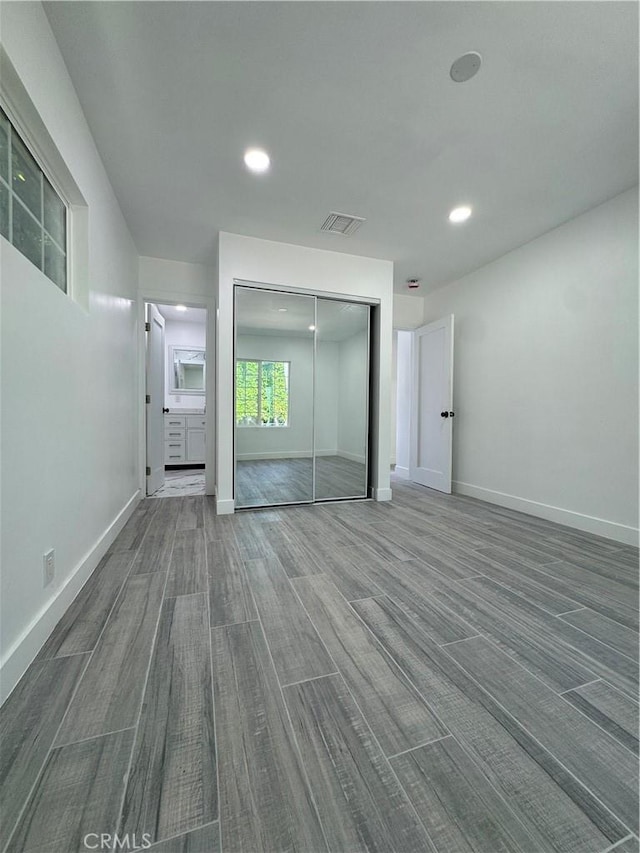 5230 Seville Ave, Encino, CA 91436 - unfurnished bedroom featuring a closet, wood finished floors, and recessed lighting