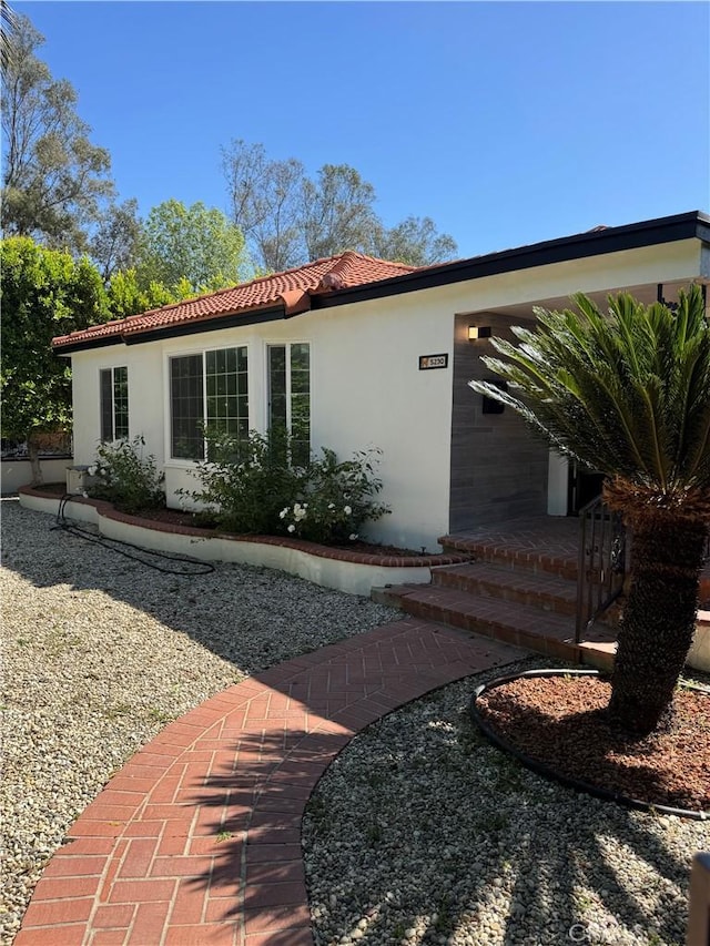 5230 Seville Ave, Encino, CA 91436 - view of side of property featuring stucco siding and a tiled roof
