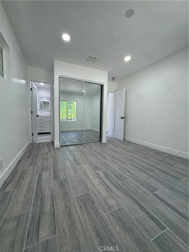 5230 Seville Ave, Encino, CA 91436 - unfurnished bedroom with wood finished floors, a closet, and recessed lighting