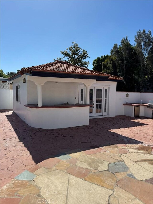 5230 Seville Ave, Encino, CA 91436 - back of house with french doors, a tiled roof, area for grilling, and a patio