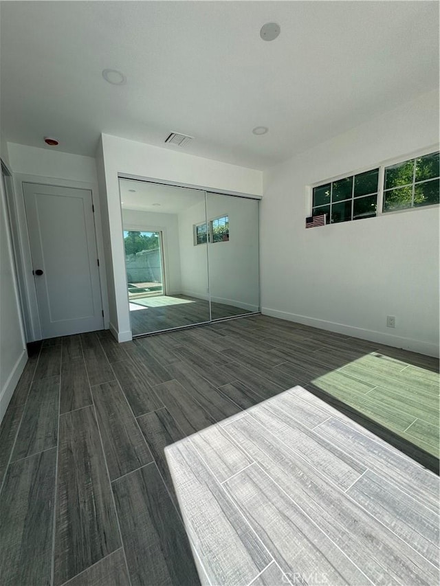 5230 Seville Ave, Encino, CA 91436 - unfurnished bedroom featuring dark wood finished floors and a closet