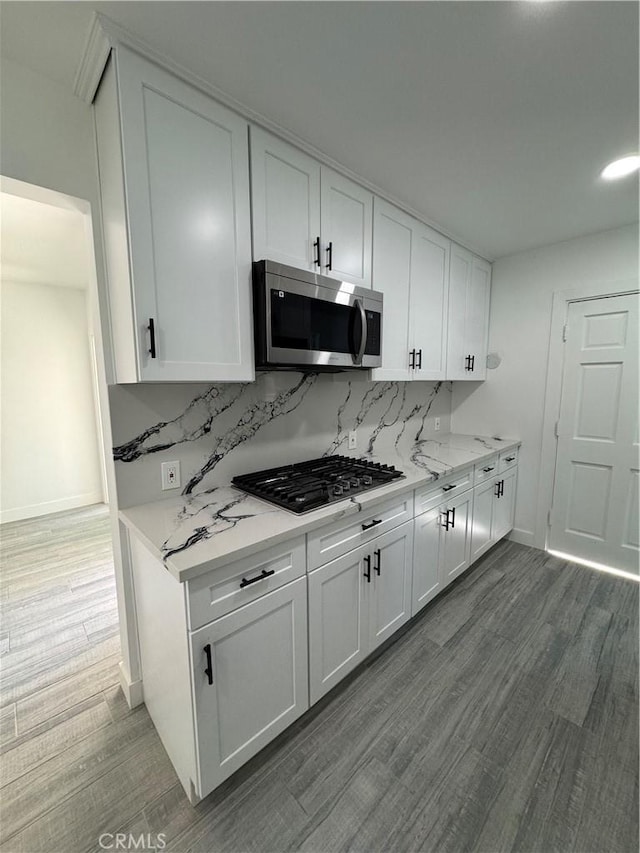 5230 Seville Ave, Encino, CA 91436 - kitchen featuring stainless steel appliances, white cabinetry, and tasteful backsplash