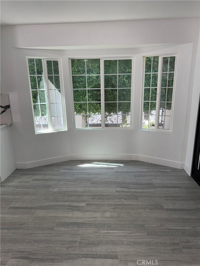 5230 Seville Ave, Encino, CA 91436 - spare room with healthy amount of natural light and wood finished floors