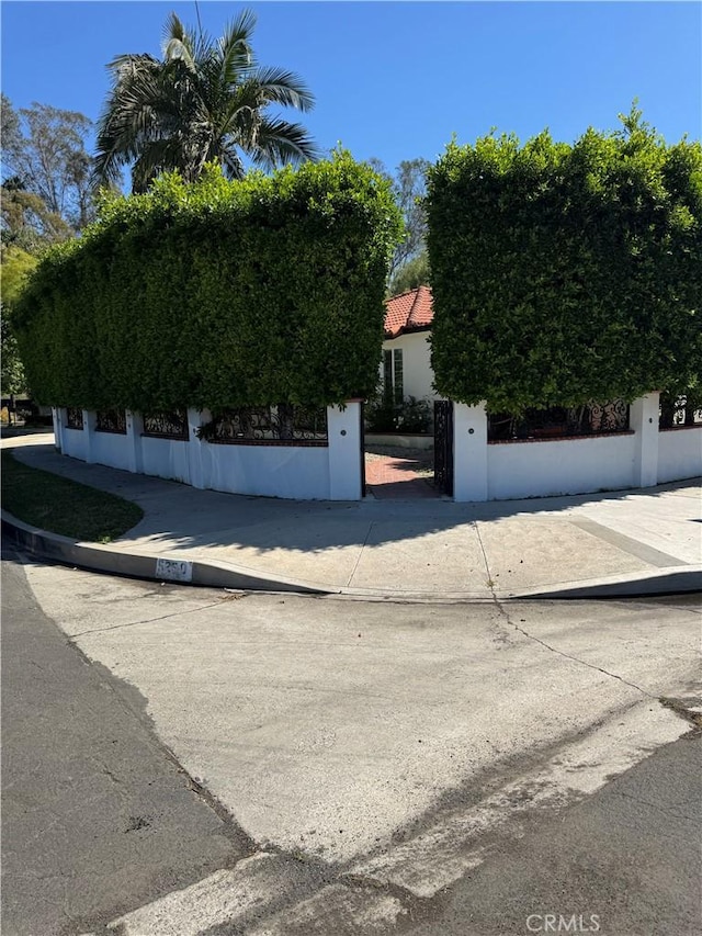 5230 Seville Ave, Encino, CA 91436 - obstructed view of property featuring stucco siding and a fenced front yard