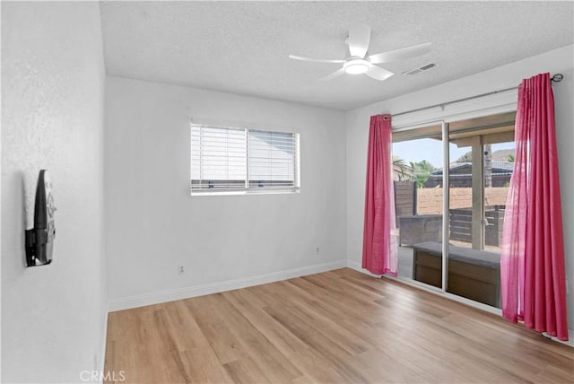 23609 Canyon Lake Dr N, Canyon Lake, CA 92587 - empty room with wood finished floors, a textured ceiling, and a ceiling fan