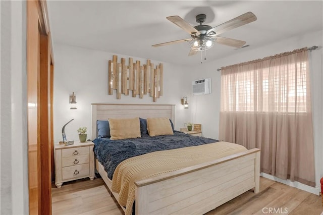 23609 Canyon Lake Dr N, Canyon Lake, CA 92587 - bedroom featuring light wood-style floors, a wall mounted AC, and ceiling fan