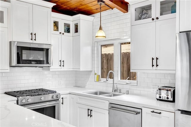 24932 La Cresta Dr, Dana Point, CA 92629 - kitchen featuring appliances with stainless steel finishes, wood ceiling, pendant lighting, light countertops, and white cabinetry