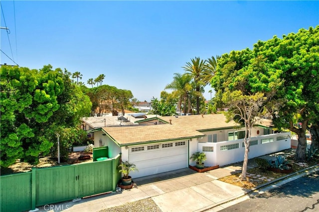 24932 La Cresta Dr, Dana Point, CA 92629 - view of front of home with driveway, a fenced front yard, an attached garage, stucco siding, and a gate