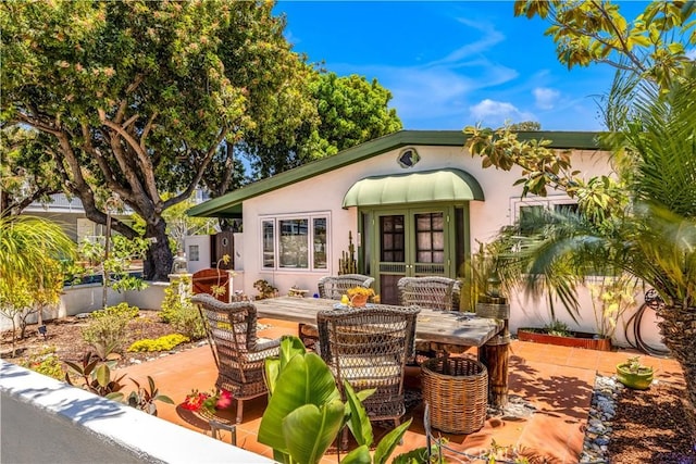 24932 La Cresta Dr, Dana Point, CA 92629 - view of front of property featuring stucco siding, a patio, outdoor dining area, and french doors