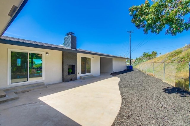 2451 Helix St, Spring Valley, CA 91977 - back of property featuring a chimney, brick siding, a patio, and stucco siding