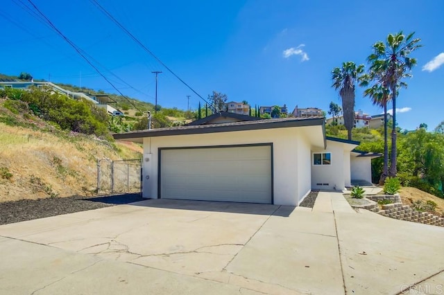 2451 Helix St, Spring Valley, CA 91977 - view of front of house with stucco siding, driveway, and an attached garage