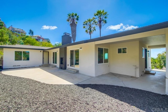 2451 Helix St, Spring Valley, CA 91977 - back of house featuring stucco siding, a chimney, and a patio area