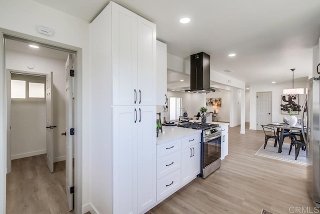 2451 Helix St, Spring Valley, CA 91977 - kitchen featuring stainless steel appliances, island range hood, light wood finished floors, white cabinetry, and recessed lighting