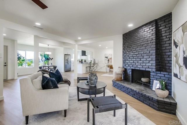 2451 Helix St, Spring Valley, CA 91977 - living area featuring light wood-style floors, recessed lighting, and a brick fireplace