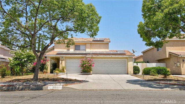 1808 Cave St, Redlands, CA 92374 - view of front facade with solar panels, concrete driveway, stucco siding, and a tile roof