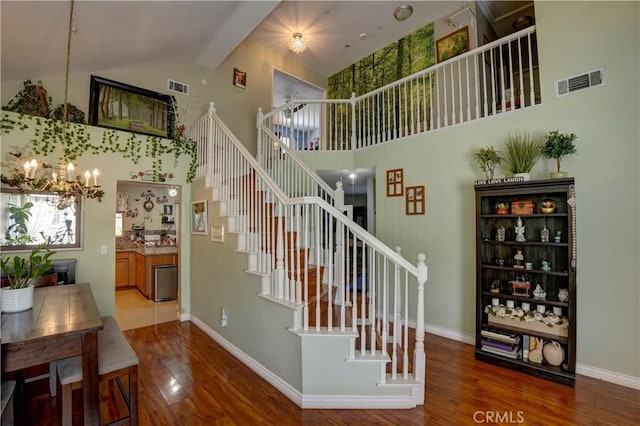 1808 Cave St, Redlands, CA 92374 - stairs featuring high vaulted ceiling, a chandelier, and wood finished floors