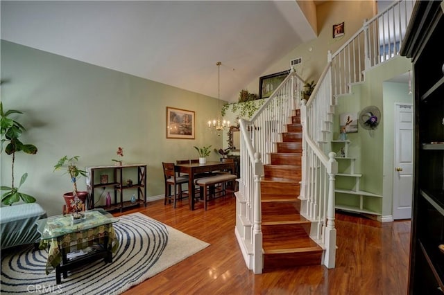 1808 Cave St, Redlands, CA 92374 - stairway with a chandelier, wood finished floors, and high vaulted ceiling