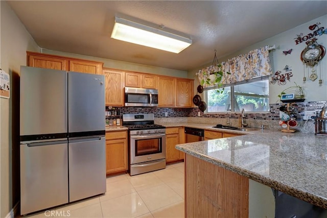 1808 Cave St, Redlands, CA 92374 - kitchen with stainless steel appliances, decorative backsplash, light stone counters, light tile patterned floors, and a peninsula