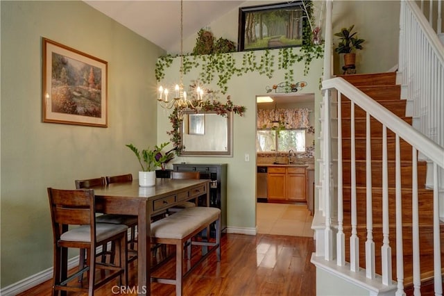 1808 Cave St, Redlands, CA 92374 - dining room with a chandelier, wood finished floors, stairway, and high vaulted ceiling