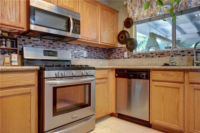 1808 Cave St, Redlands, CA 92374 - kitchen featuring stainless steel appliances, tasteful backsplash, light tile patterned floors, and light stone countertops