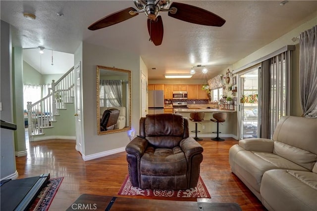 1808 Cave St, Redlands, CA 92374 - living area with a textured ceiling, ceiling fan, light wood-type flooring, stairs, and vaulted ceiling