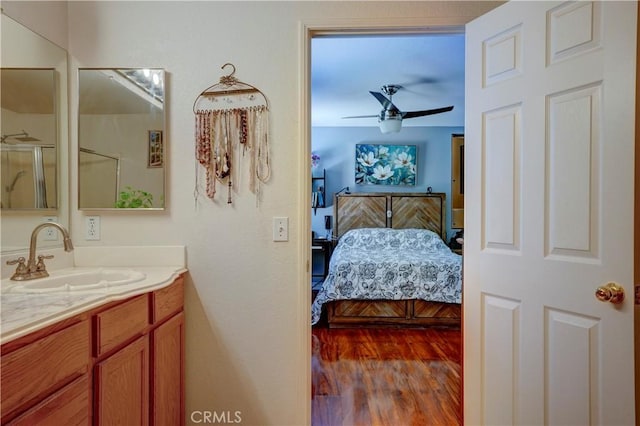 1808 Cave St, Redlands, CA 92374 - full bath with connected bathroom, vanity, wood finished floors, an enclosed shower, and ceiling fan