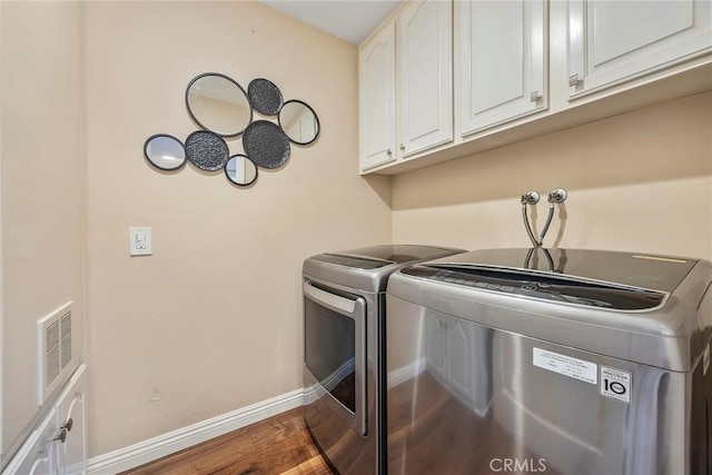 21971 Cayuga Ln N, Lake Forest, CA 92630 - laundry room with wood finished floors, washing machine and dryer, and cabinet space
