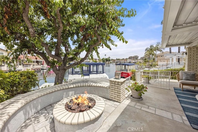 21971 Cayuga Ln N, Lake Forest, CA 92630 - view of patio featuring a water view, an outdoor fire pit, and a boat dock