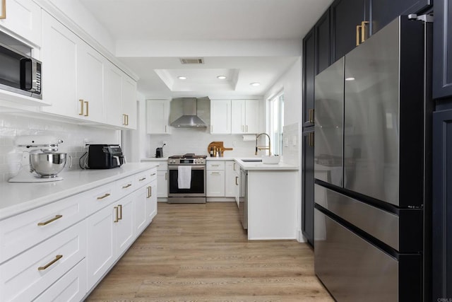 4576 Mariners Bay, Oceanside, CA 92057 - kitchen with appliances with stainless steel finishes, wall chimney exhaust hood, light countertops, decorative backsplash, and white cabinets