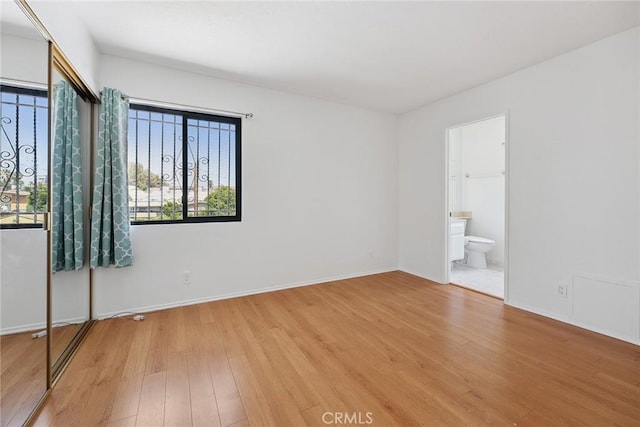 13012 Valleyheart Dr Unit 8, Studio City, CA 91604 - unfurnished bedroom with light wood-style floors and connected bathroom