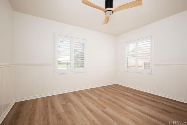 1713 Stewart St, Oceanside, CA 92054 - spare room with wood finished floors, wainscoting, and ceiling fan