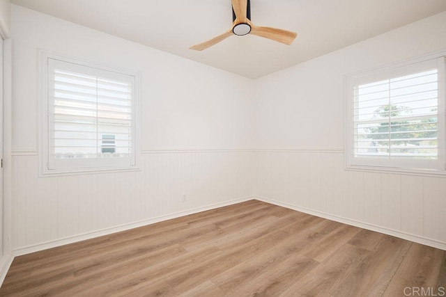 1713 Stewart St, Oceanside, CA 92054 - spare room featuring light wood-style floors, wainscoting, and a ceiling fan