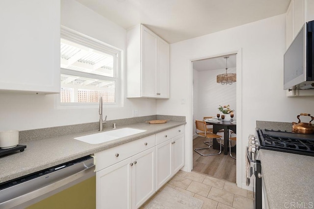 1713 Stewart St, Oceanside, CA 92054 - kitchen with appliances with stainless steel finishes, white cabinets, light countertops, and light tile patterned flooring
