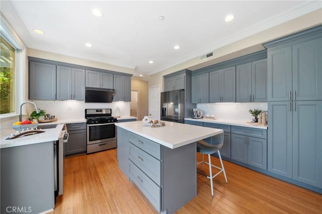 2 Corte Arbertura, San Clemente, CA 92673 - kitchen featuring appliances with stainless steel finishes, a kitchen island, a kitchen breakfast bar, extractor fan, and light countertops