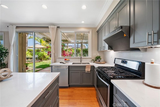 2 Corte Arbertura, San Clemente, CA 92673 - kitchen featuring stainless steel appliances, ornamental molding, gray cabinets, wall chimney range hood, and light countertops