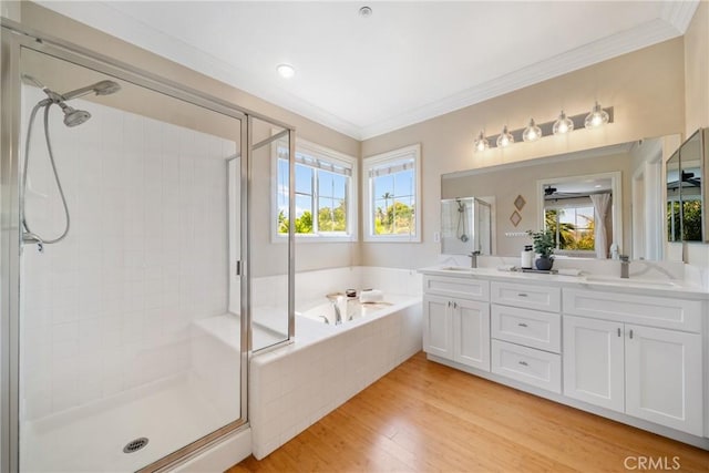 2 Corte Arbertura, San Clemente, CA 92673 - full bathroom featuring a shower stall, a garden tub, double vanity, wood finished floors, and crown molding