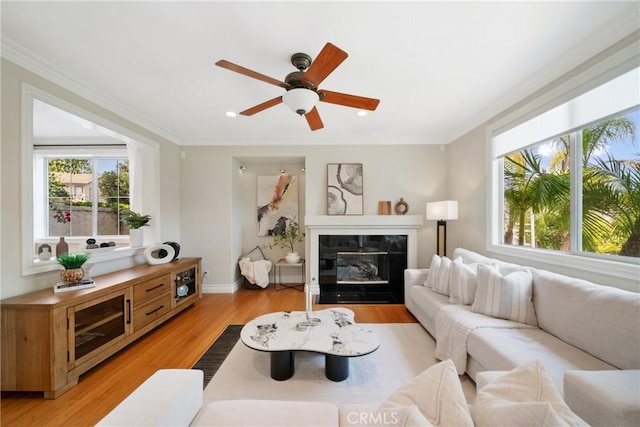 2 Corte Arbertura, San Clemente, CA 92673 - living area with plenty of natural light, crown molding, light wood-style flooring, ceiling fan, and a fireplace with flush hearth