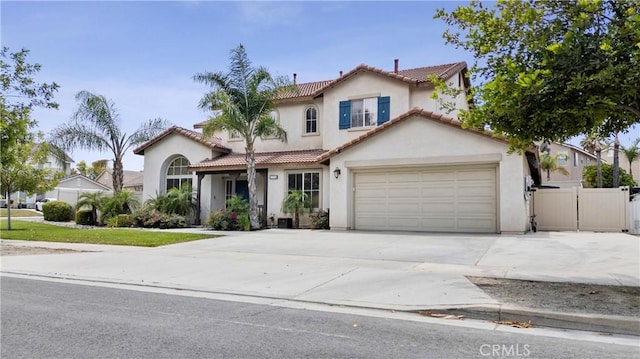 17733 Willow Dr, Riverside, CA 92503 - mediterranean / spanish-style house with stucco siding, concrete driveway, a tile roof, and a garage