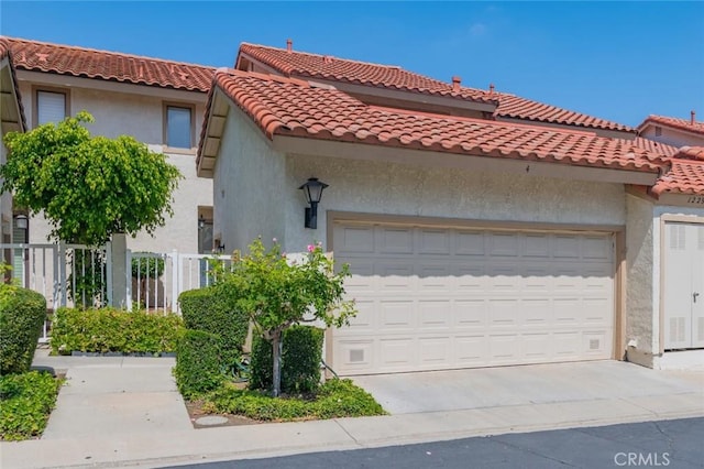 1229 Porto Grande Unit 4, Diamond Bar, CA 91765 - view of front of property featuring a garage, concrete driveway, stucco siding, and a tile roof