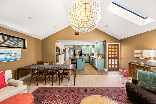 5429 E The Toledo, Long Beach, CA 90803 - dining space featuring light wood finished floors, vaulted ceiling, and a skylight