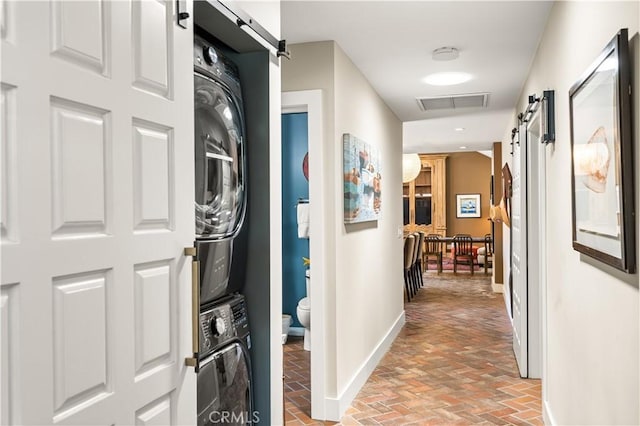 5429 E The Toledo, Long Beach, CA 90803 - hall with a barn door, stacked washer and clothes dryer, and brick flooring