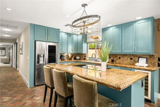 5429 E The Toledo, Long Beach, CA 90803 - kitchen featuring stainless steel fridge, light stone countertops, tasteful backsplash, recessed lighting, and a kitchen island