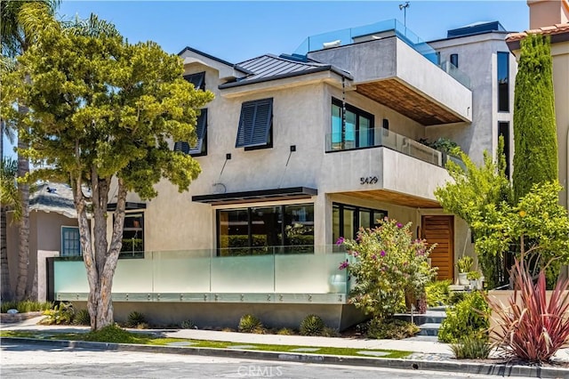5429 E The Toledo, Long Beach, CA 90803 - view of property exterior with a standing seam roof, a metal roof, and stucco siding