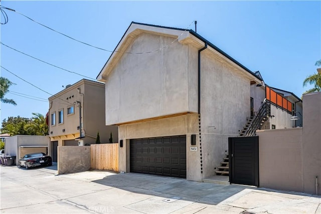5429 E The Toledo, Long Beach, CA 90803 - view of side of property with stairway, driveway, and an attached garage